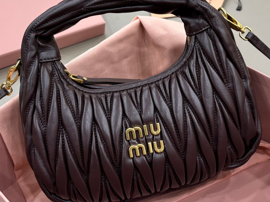 MiuMiu black ruched mini bag front with “miumiu” logo and arched top opening