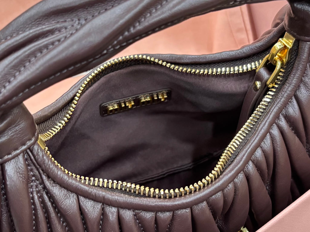 MiuMiu brown leather mini bag interior pocket with gold zipper and stitched edges