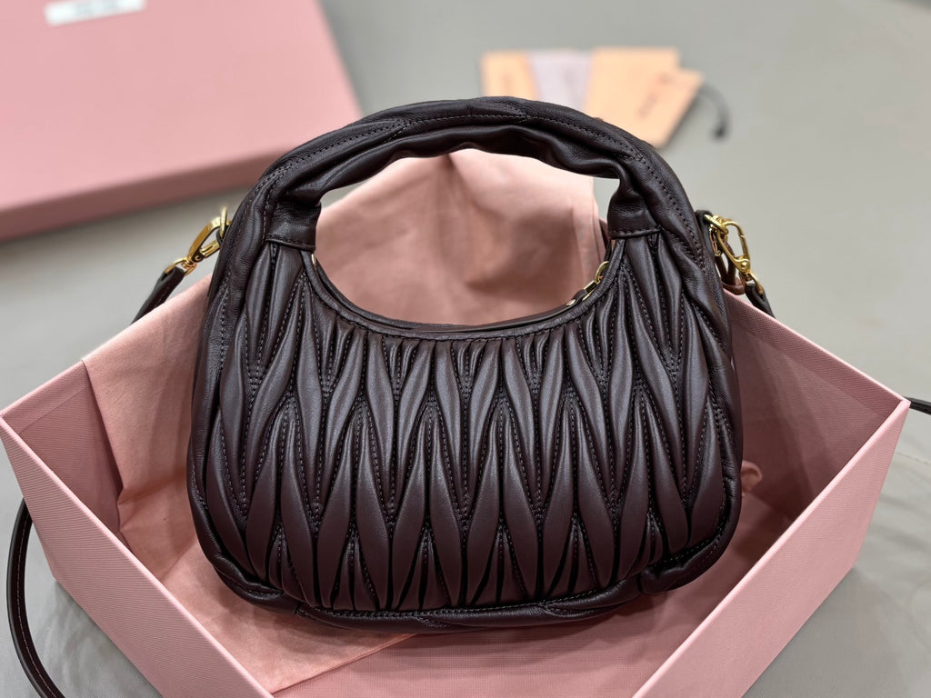 MiuMiu black quilted mini bag with ruched texture and gold-tone handles