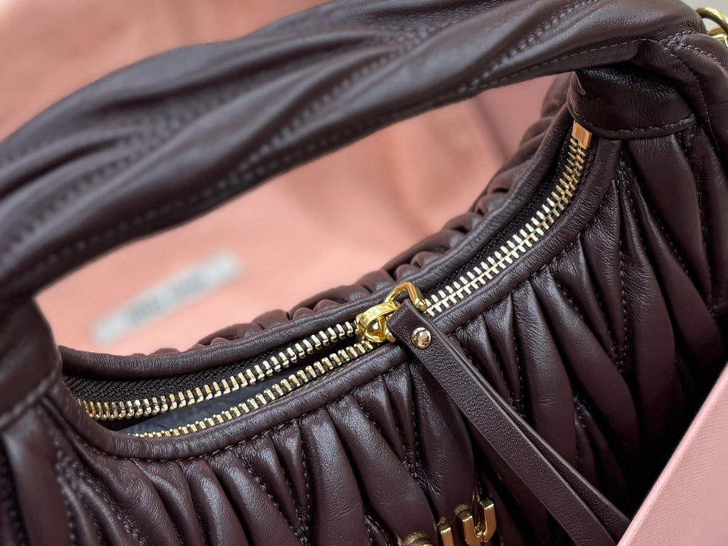 MiuMiu black ruched mini bag with gold zipper trim along front seam