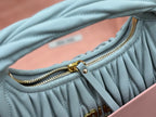 MiuMiu light blue pleated hobo bag with gold zipper pull and hardware