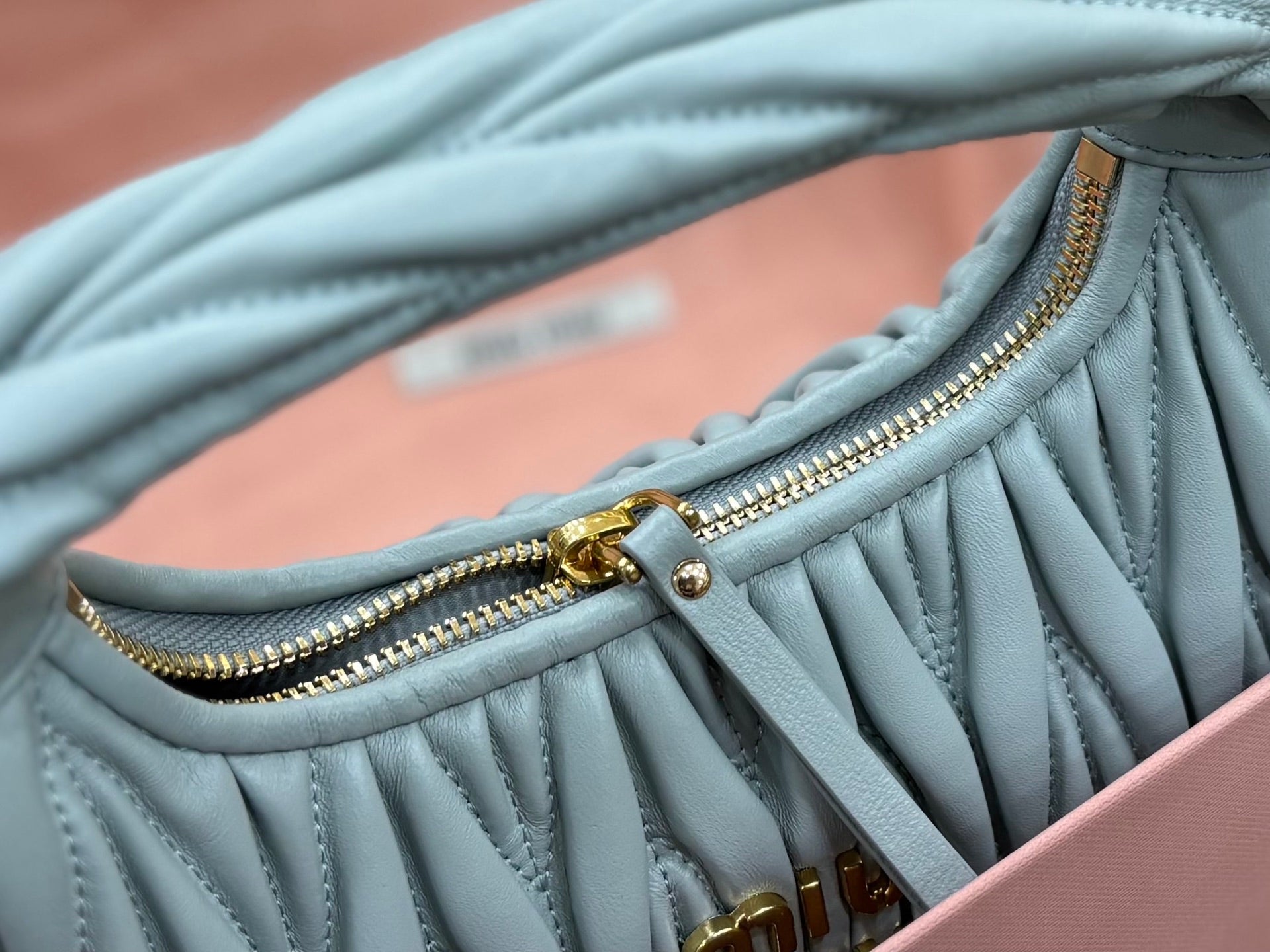MiuMiu light blue pleated hobo bag with gold zipper pull and hardware