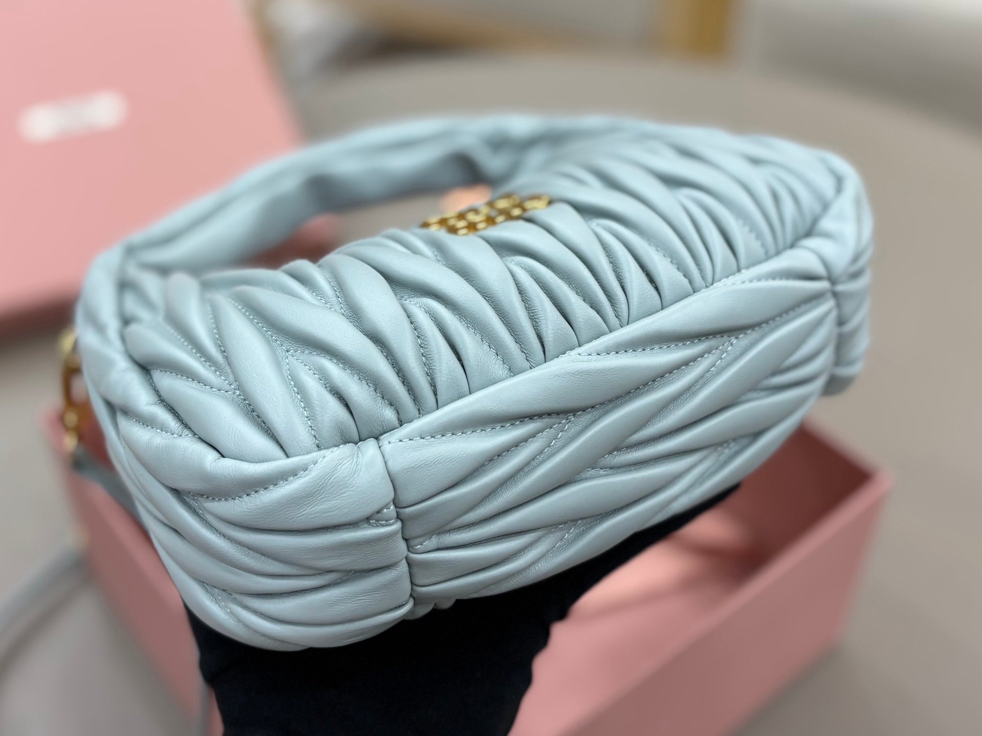 MiuMiu light blue pleated hobo bag with gold chain strap detail