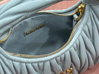 MiuMiu light blue hobo bag interior with gold zipper chain and logo tag