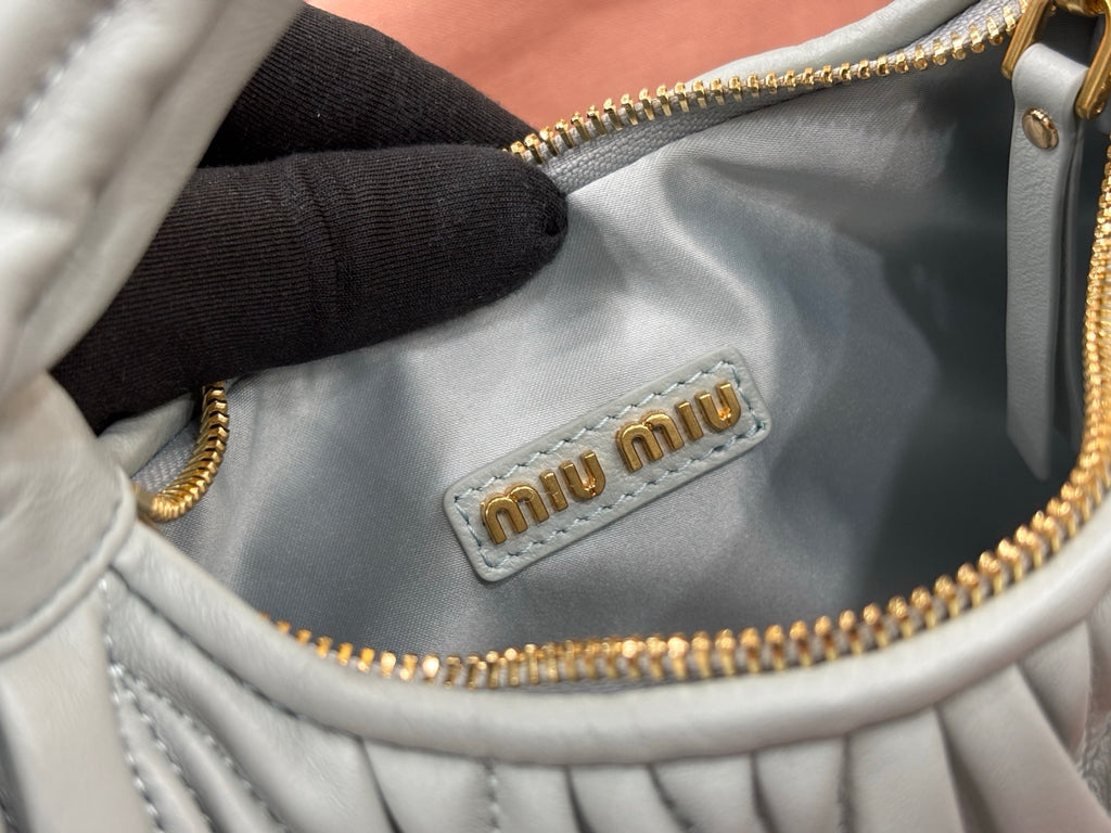 MiuMiu light blue hobo bag with miu miu logo patch and gold zipper trim