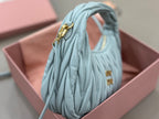 MiuMiu light blue hobo bag with gold-tone top clasp and pleated texture