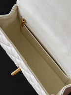 White quilted mini handbag interior view with fabric lining and side opening
