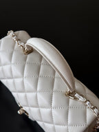 Chanel quilted white shoulder bag with chain strap and curved top opening