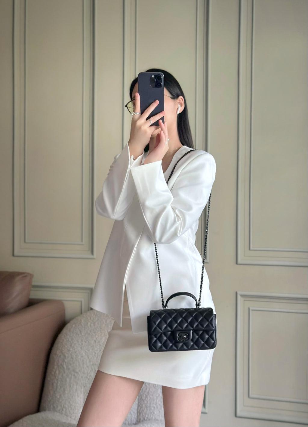 Chanel quilted leather mini bag worn with chain strap, black