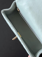 Chanel bag in light blue with open top and gold-tone zipper on the inner edge