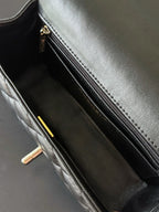 Quilted handbag interior with zip pocket and gold zipper pull, dark lining