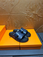 Hermes dark blue leather slide sandals, front view with open toe and strap