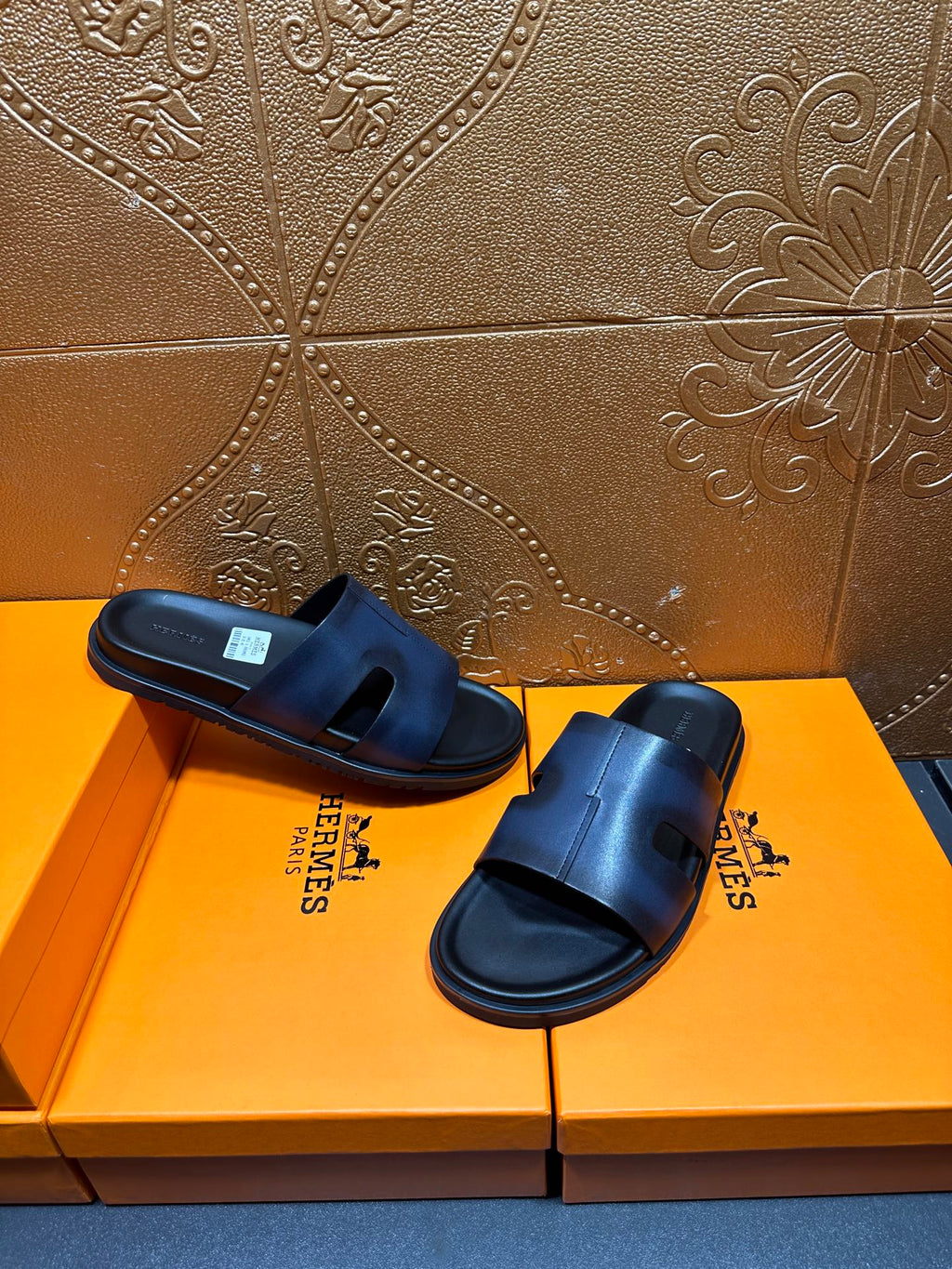 Hermes dark blue leather slide sandals on a pair, side-by-side view
