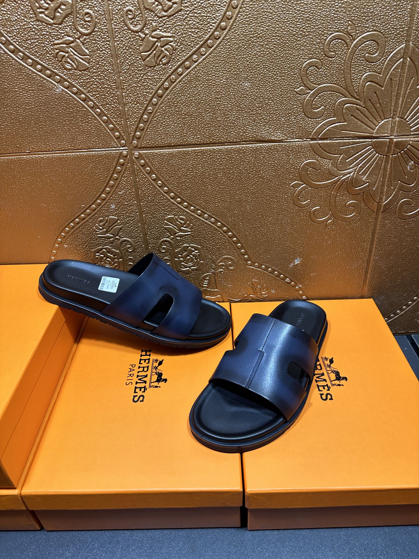 Hermes dark blue leather slide sandals on a pair, side-by-side view
