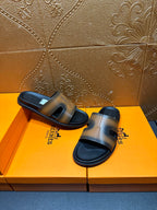Hermes slide sandals, gray-tan wide straps on black soles