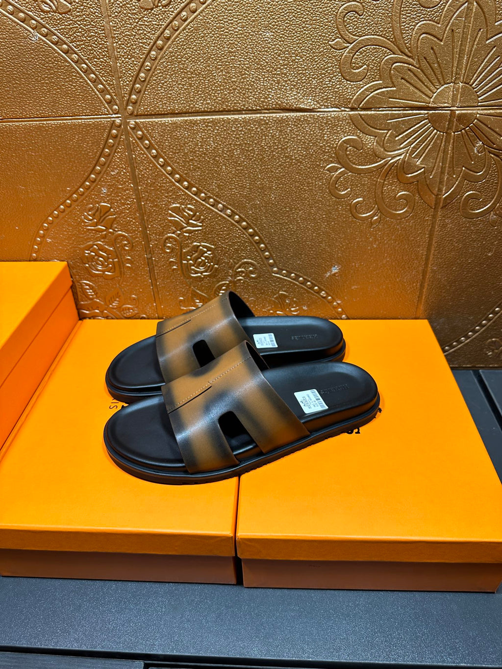 Hermes slide sandals, gray-tan straps over black soles, open toe design