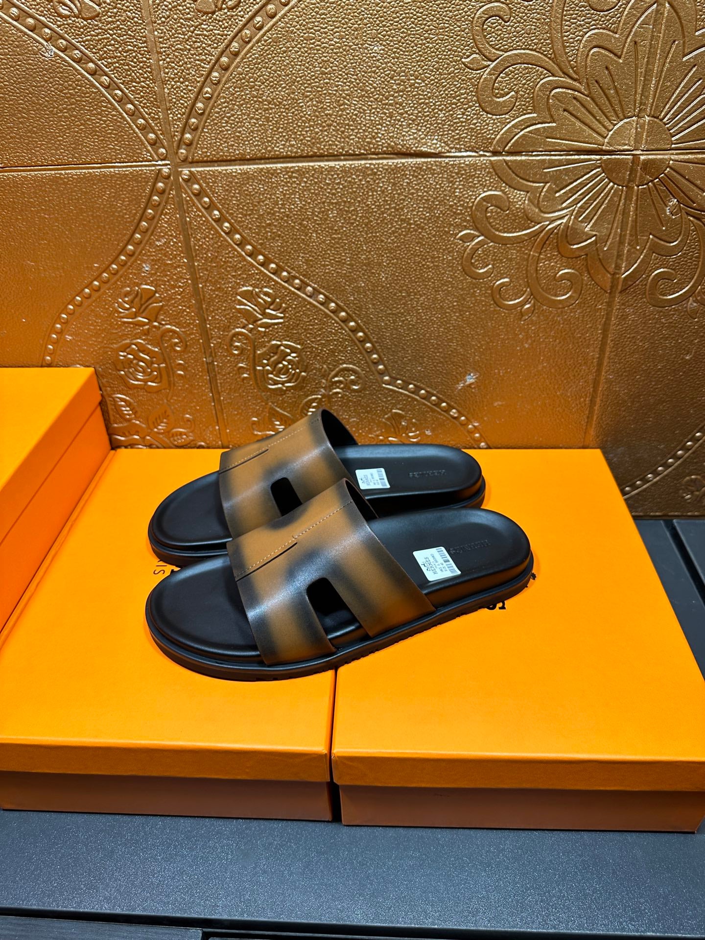 Hermes slide sandals, gray-tan straps over black soles, open toe design