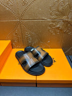 Hermes slide sandals with wide gray-tan straps and black molded footbed