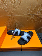 Hermes slide sandals, metallic blue upper with black strap detail and sole