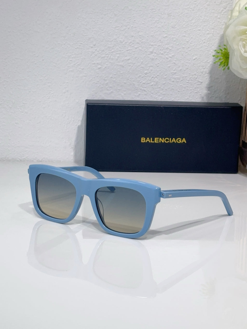Balenciaga square sunglasses with light blue frame and blue-tinted lenses