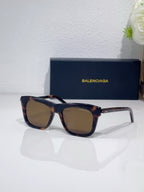Balenciaga square sunglasses with dark frame and amber-tinted lenses