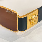 Versace rectangular sunglasses close-up, gold frame, dark lenses, Medusa temple emblem