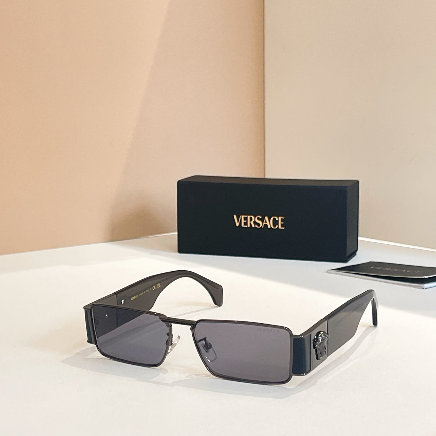 Versace rectangular sunglasses with dark lenses and dark frames, metal bridge detail