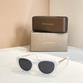 Bvlgari sunglasses with white frames and dark oval lenses, gold-tone hinge detail