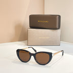 Bvlgari sunglasses with dark blue frames and brown-tinted oval lenses, gold-tone hinge
