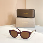 Bvlgari sunglasses with burgundy frames and brown-tinted oval lenses, gold-tone hinge