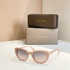 Bvlgari sunglasses with light pink frames and light lenses, gold-tone hinge detail
