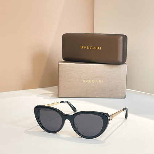 Bvlgari sunglasses with dark blue frames and dark oval lenses, gold-tone temple detail
