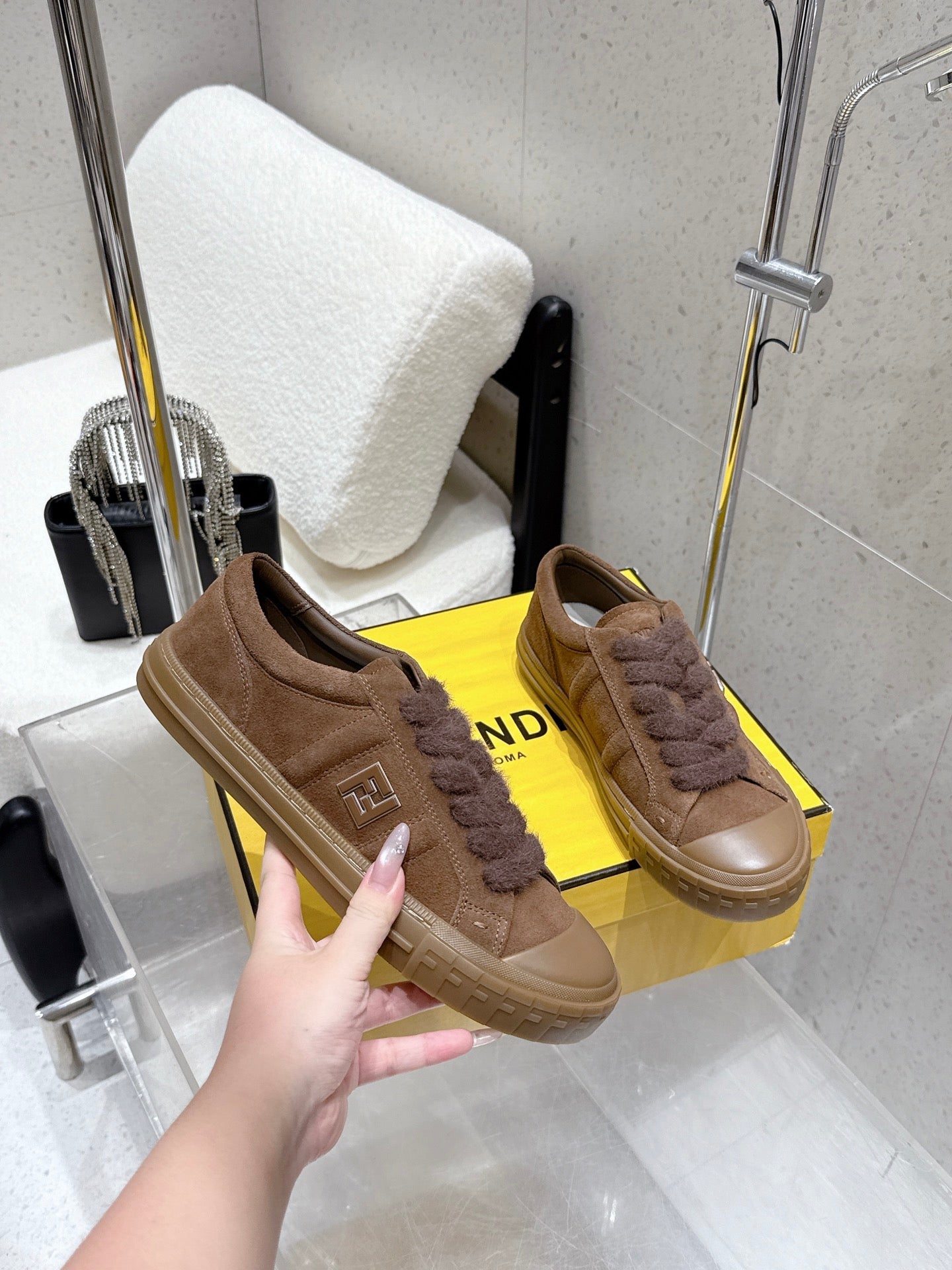 Brown suede sneakers with fuzzy laces, side logo plate and thick rubber sole