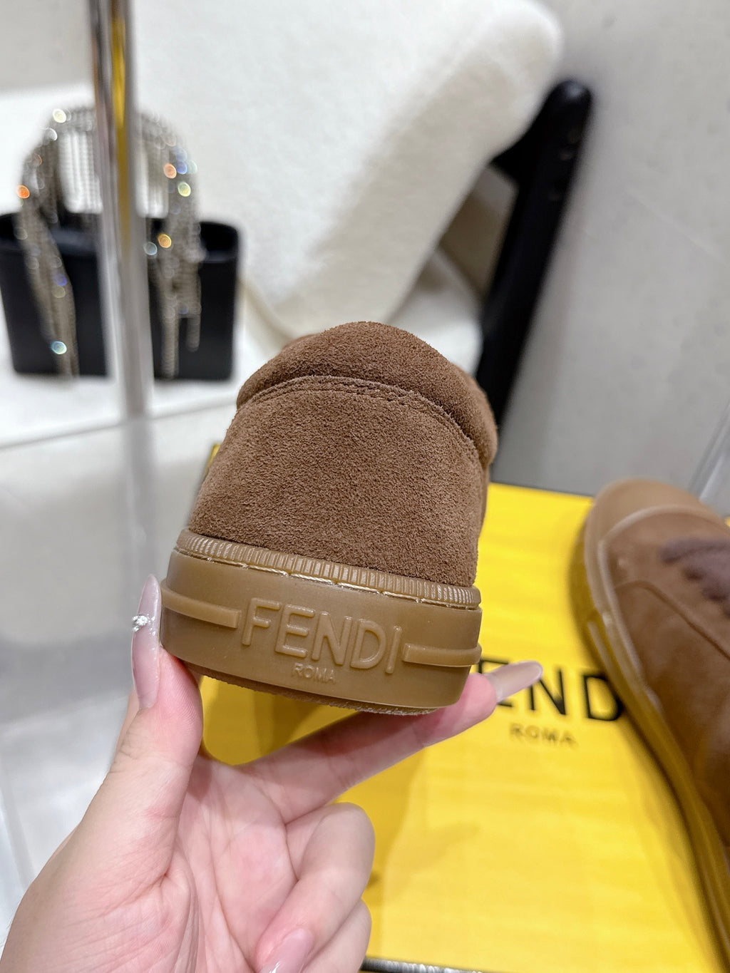 Back view of brown suede sneaker with Fendi logo heel strap on rubber sole
