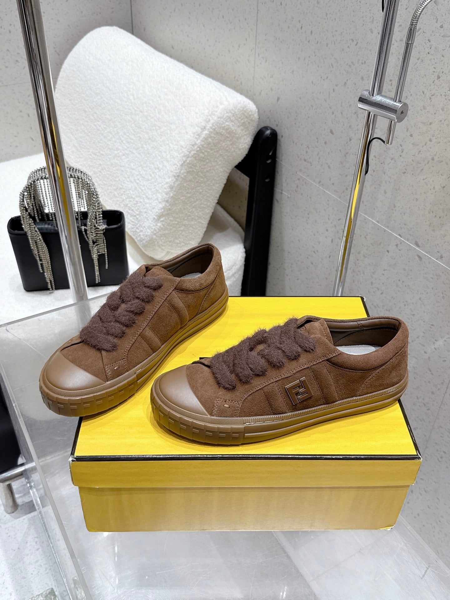 Brown low-top sneakers with lace-up front, textured trim and rubber cup sole
