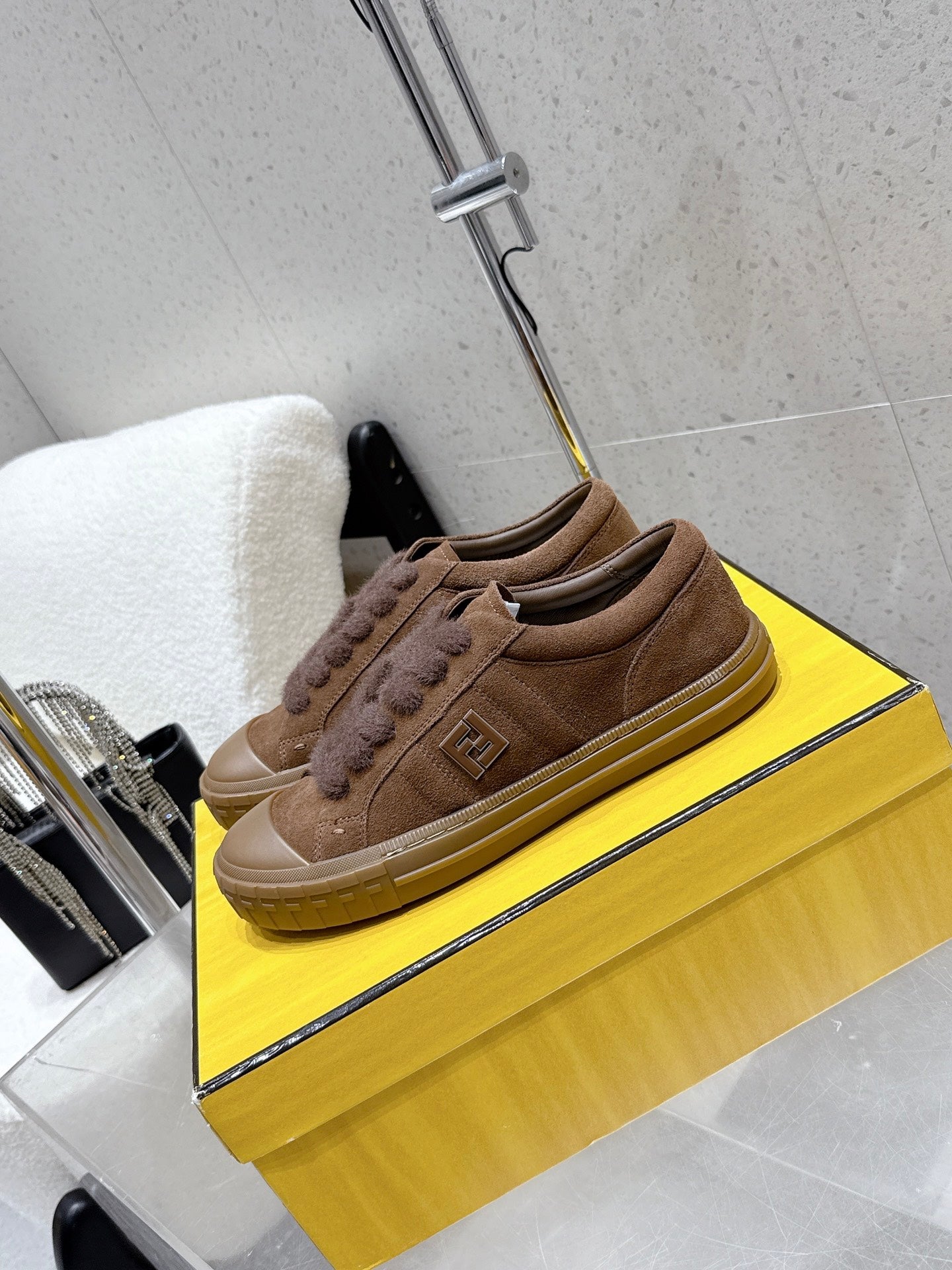 Brown suede low-top sneakers with Fendi logo on side and cushioned rubber sole