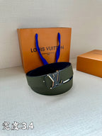 Dark green leather belt with silver logo buckle resting on a surface