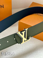 Dark green leather belt close-up with silver buckle and stitched edge