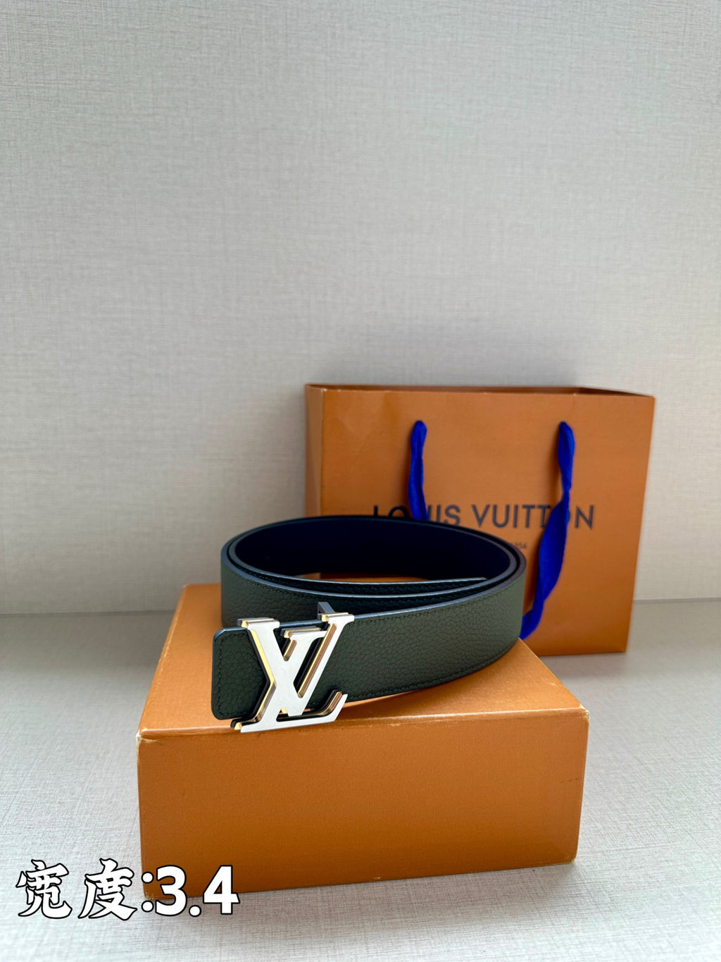 Dark green leather belt with silver LV buckle and textured leather strap