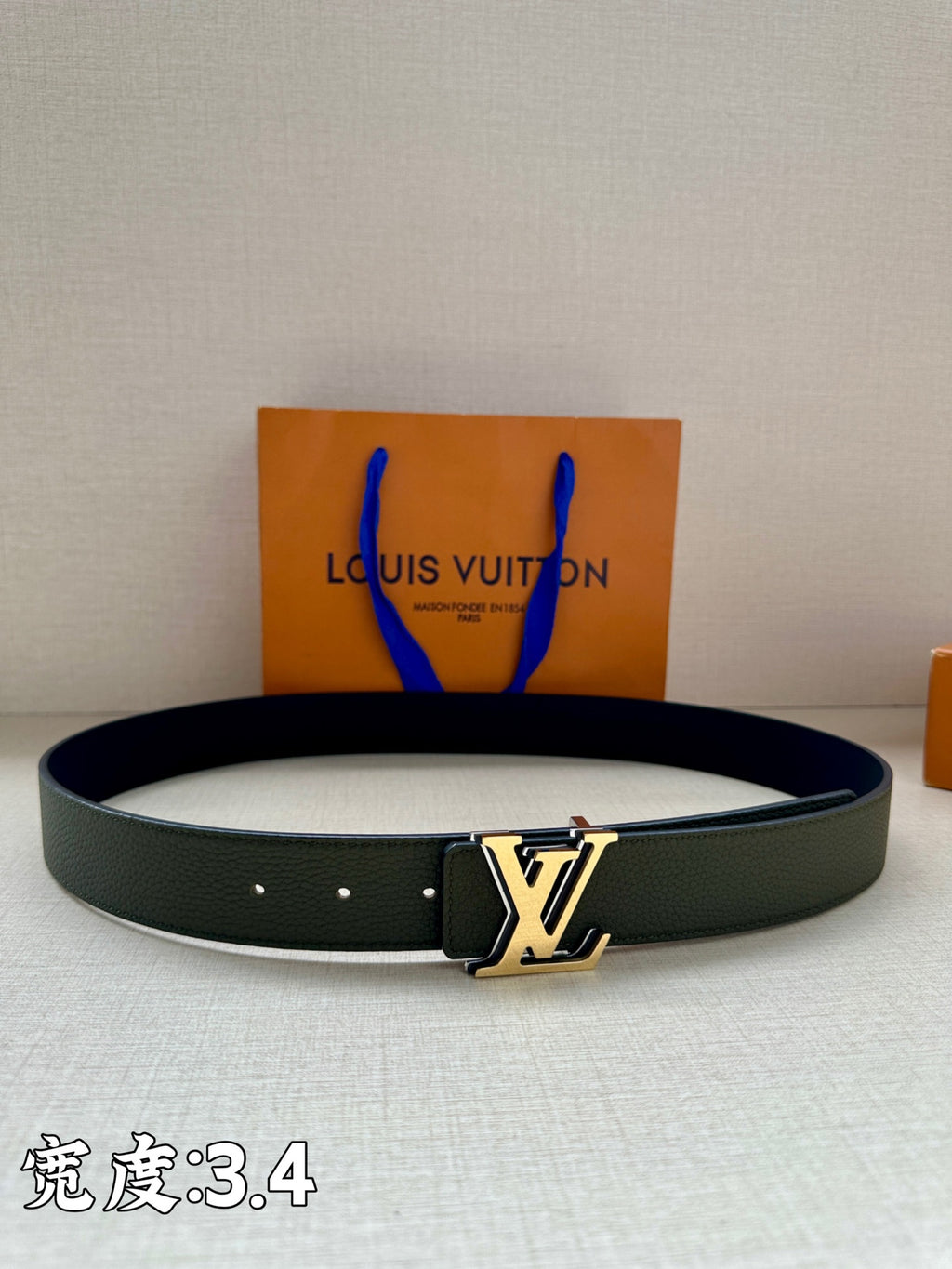 Dark green leather belt with silver LV buckle and five eyelet holes
