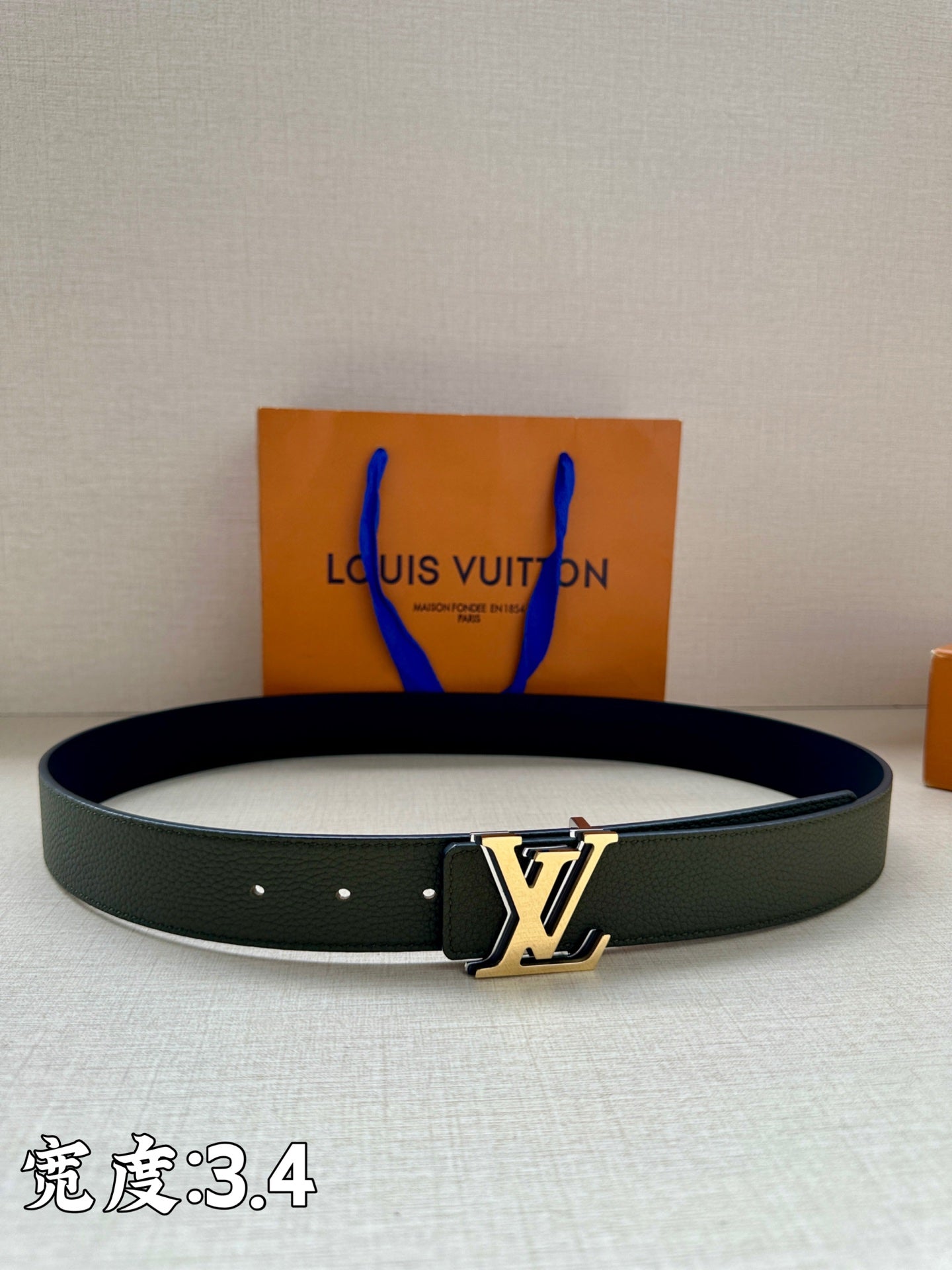 Dark green leather belt with silver LV buckle and five eyelet holes