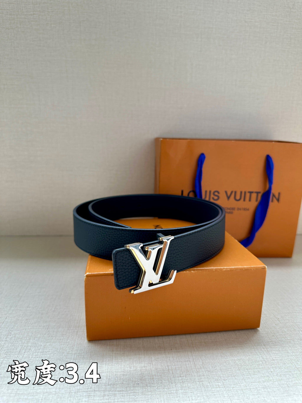 Louis Vuitton belt with dark blue strap and gold-tone LV emblem buckle