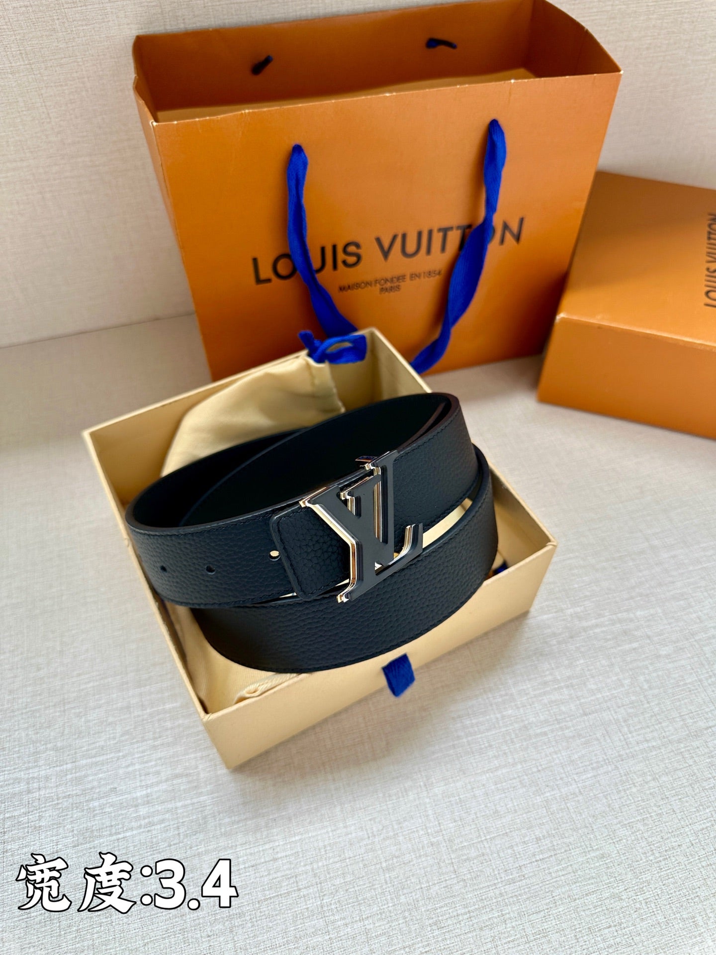 Louis Vuitton leather belt, dark blue strap with gold-tone LV buckle