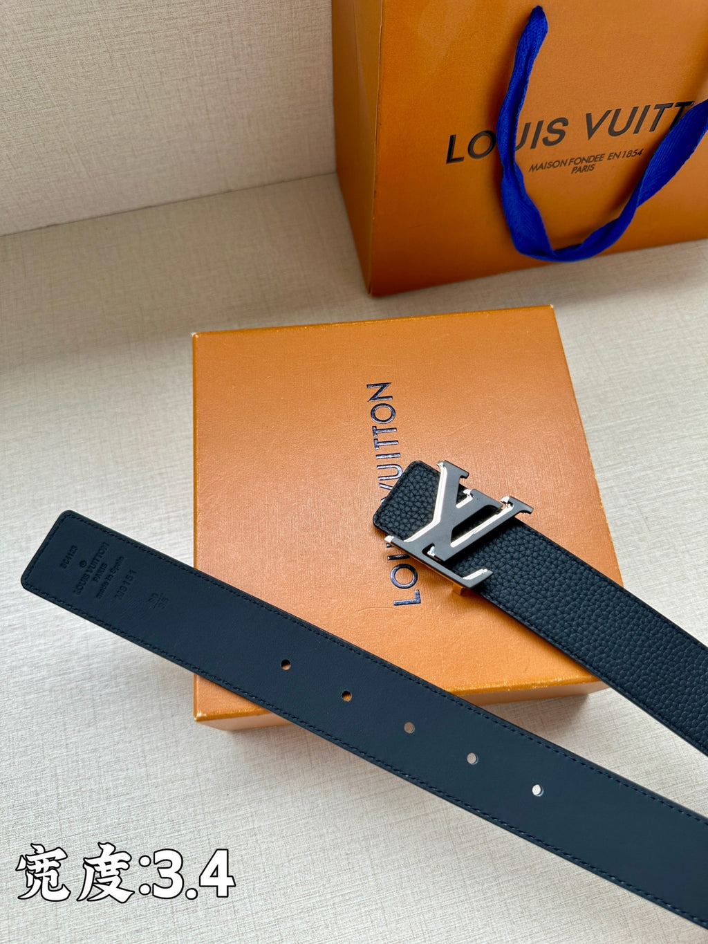 Louis Vuitton belt, dark blue leather with gold-tone LV buckle and punched holes