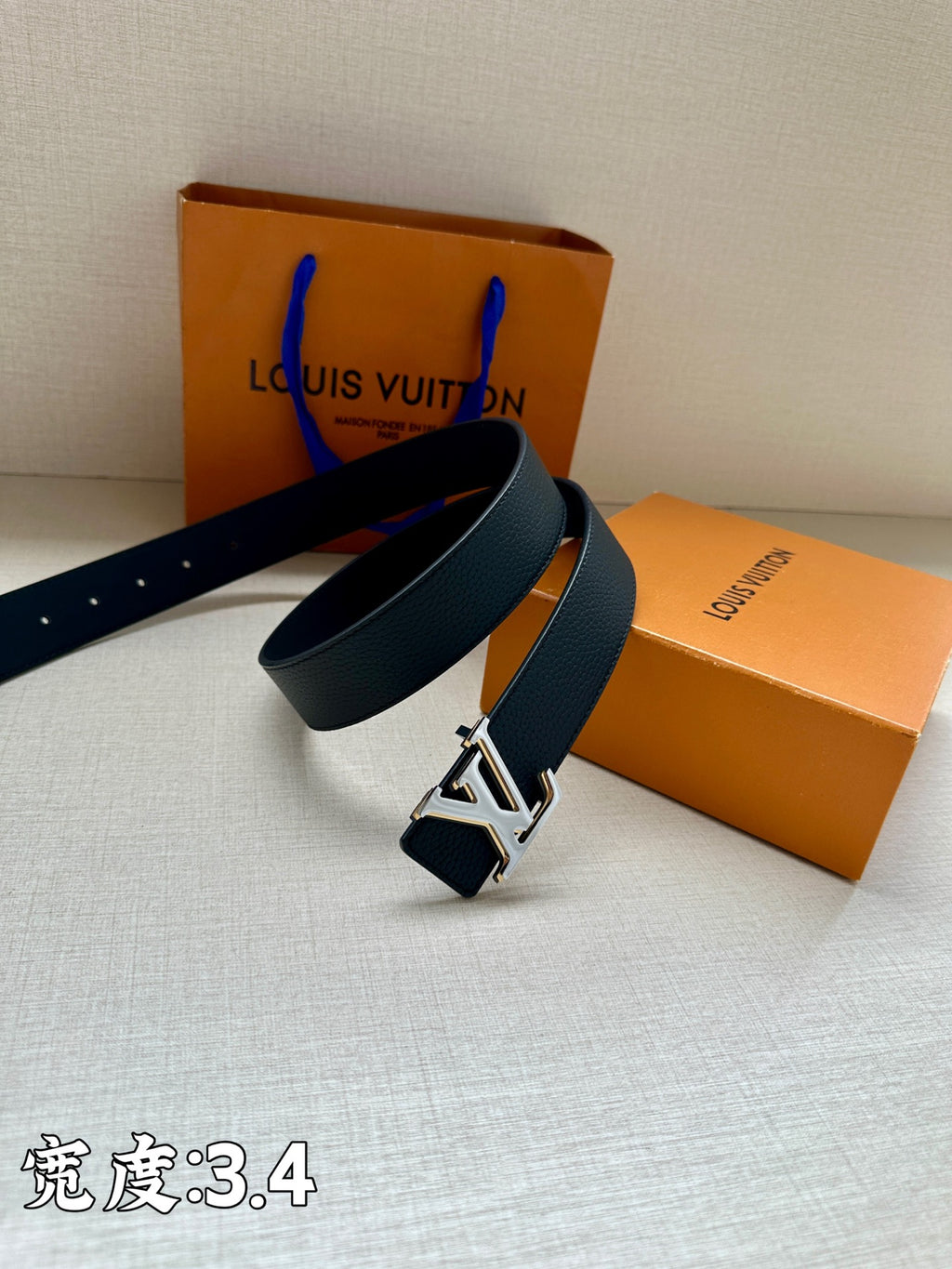 Louis Vuitton belt, dark blue leather with gold-tone LV buckle on strap