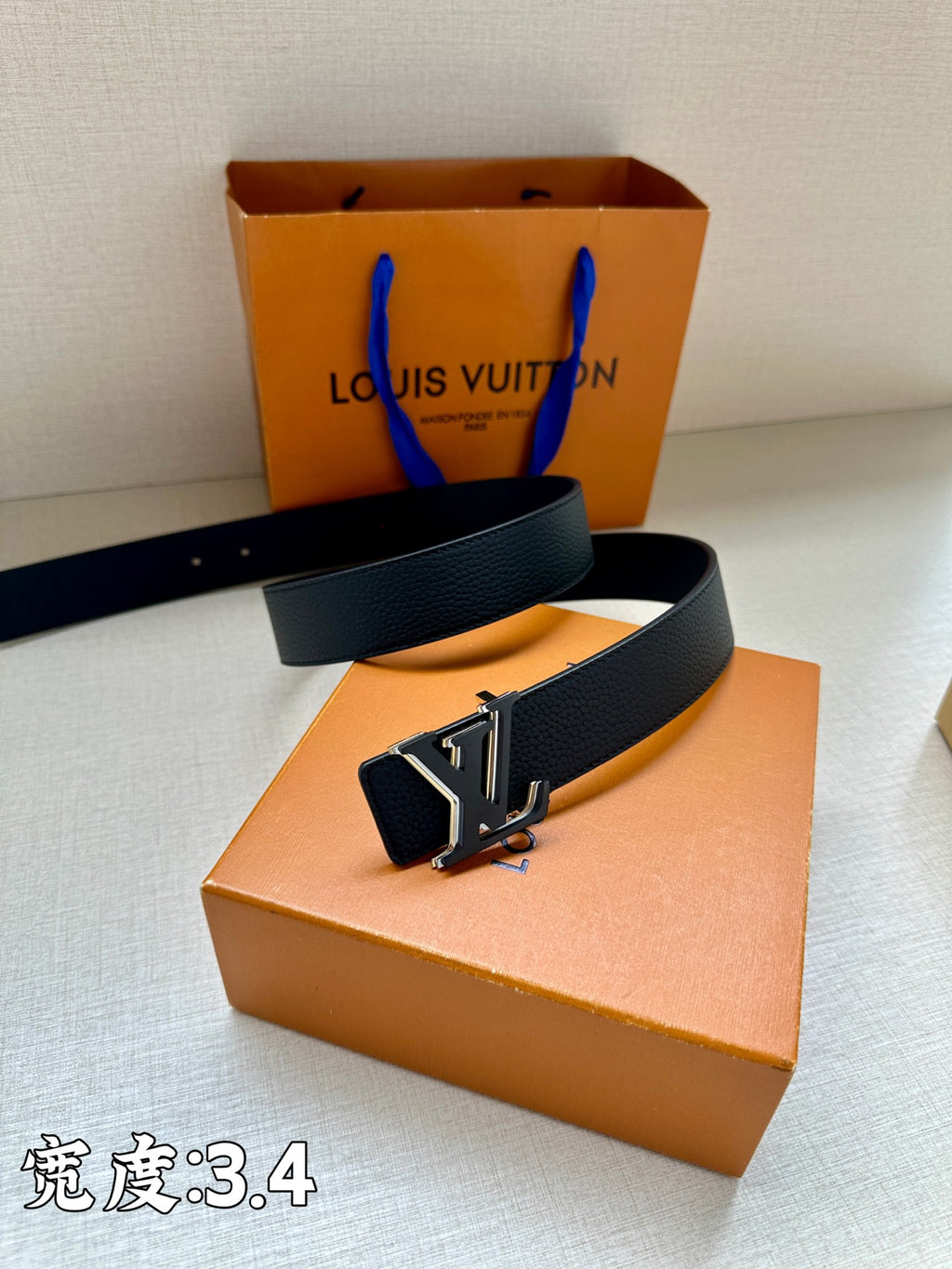 Louis Vuitton belt with dark blue strap and large gold-tone LV buckle