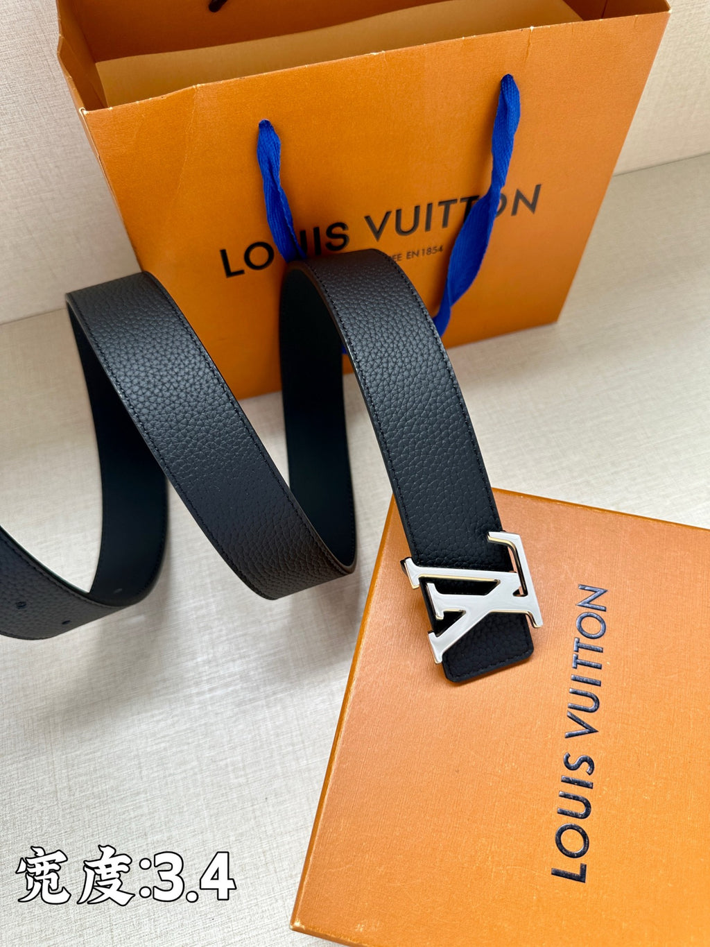 Louis Vuitton belt with dark blue leather strap and gold-tone LV buckle