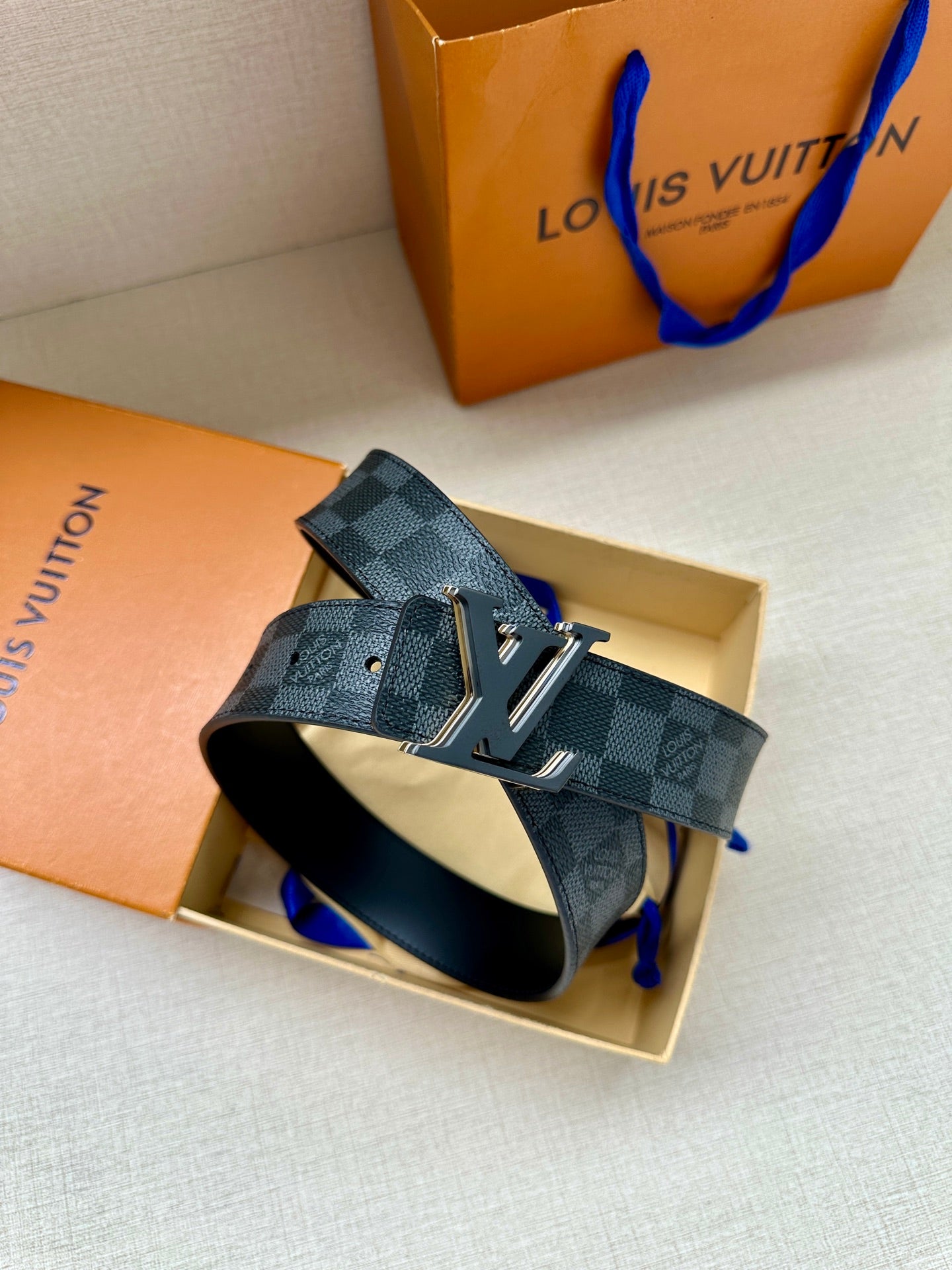Monogram belt with dark blue check strap and gold-tone buckle