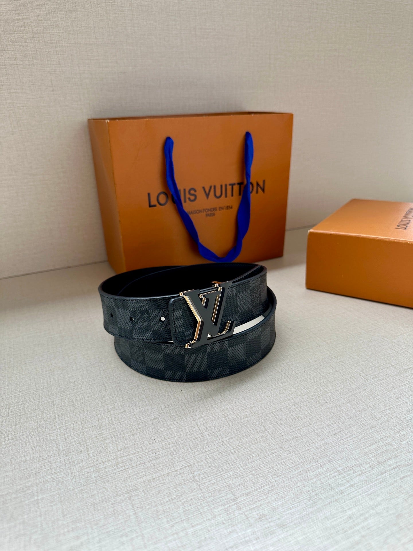 Monogram belt with dark blue check strap and gold-tone buckle