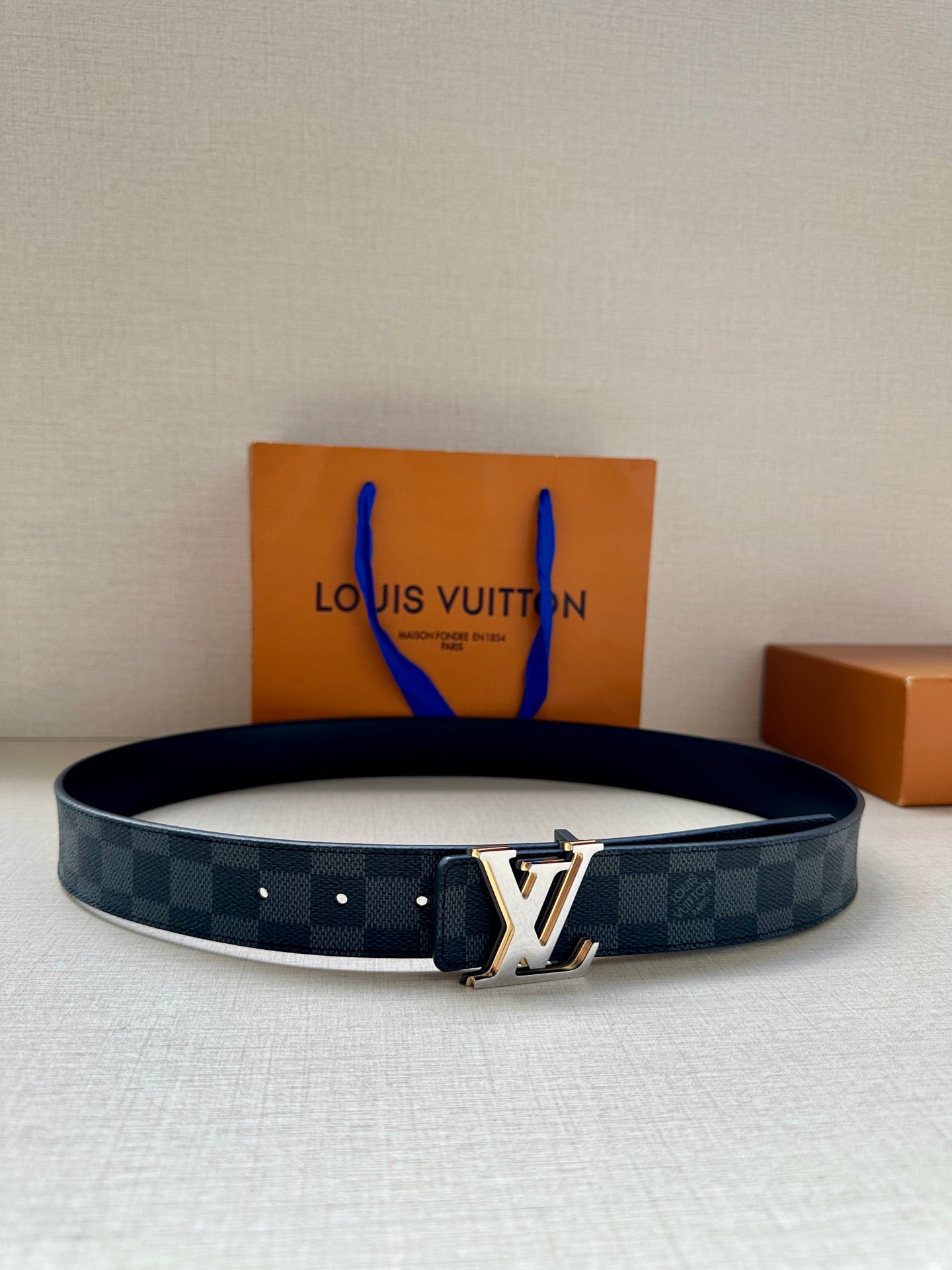 Louis Vuitton monogram belt with dark blue check strap and gold-tone buckle